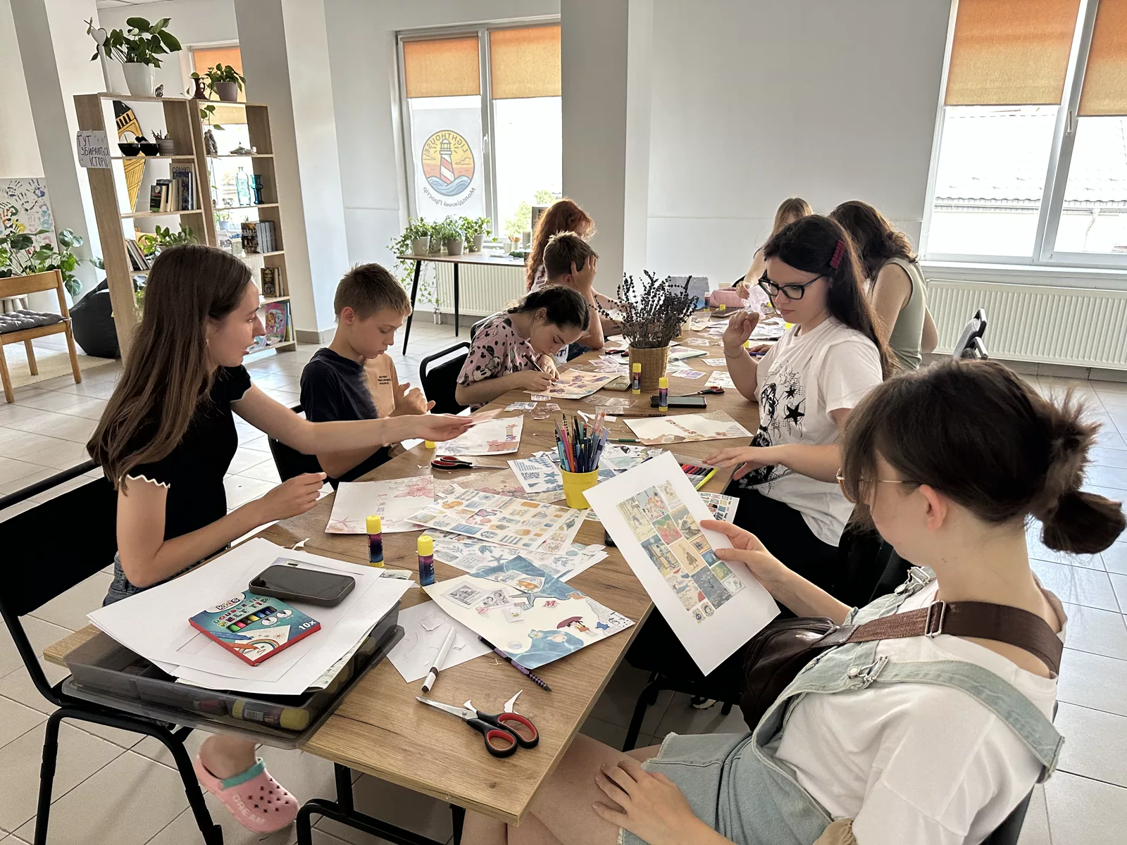 Young people working on creative projects at a table